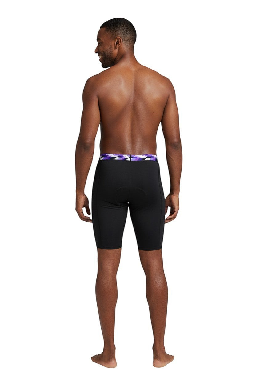 The Lifeguard Store RISE Sandies Swerve Poly Jammer swimsuit in black with a purple, white, and black geometric waistband.