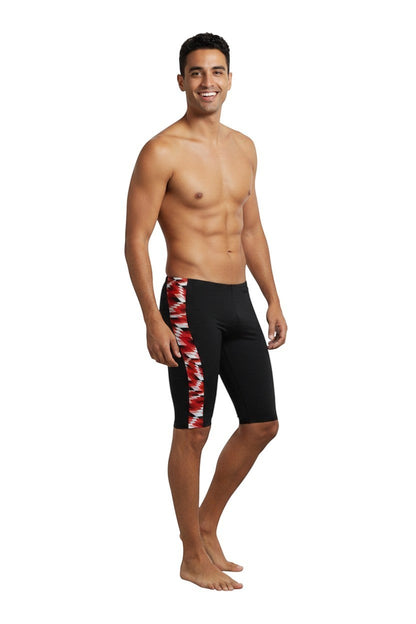 The Lifeguard Store RISE Sandies Swerve Poly Jammer swimsuit in black with a red, white, and black geometric side panel. Made of 91% Polyester/9% Spandex.
