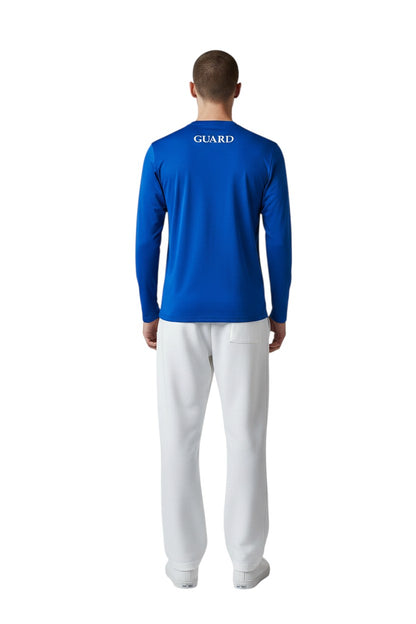 The Lifeguard Store royal blue long sleeve crew neck rashguard with GUARD text on back. Polyester-spandex blend.
