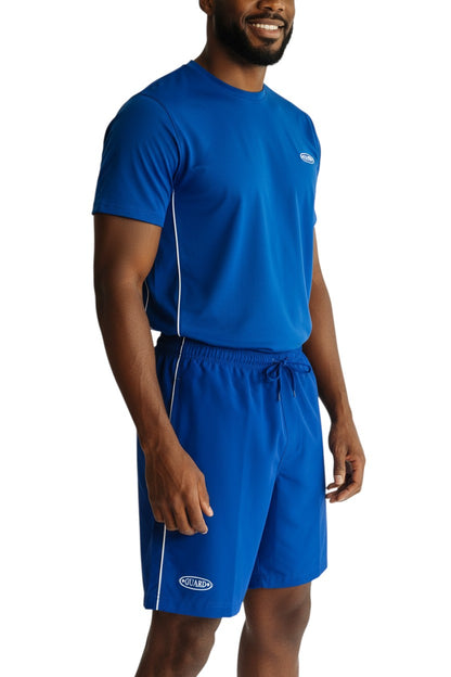 The Lifeguard Store royal blue polyester board shorts with white piping and drawstring waist. 7" inseam.
