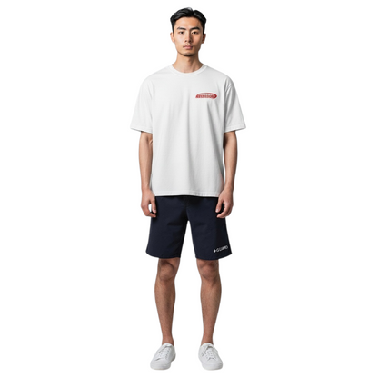 The Lifeguard Store white cotton Attendant tee worn by a model with navy shorts and white sneakers.