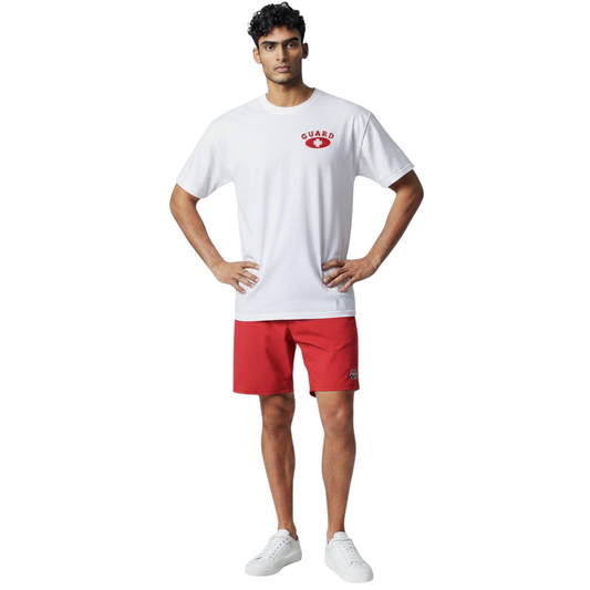 The Lifeguard Store white Dri-Fit short sleeve t-shirt with red Guard logo worn by a male model with red shorts.