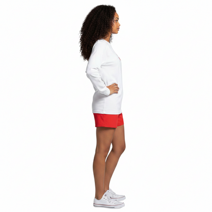 A model wearing The Lifeguard Store white long sleeve Guard tee and red shorts, side profile view.