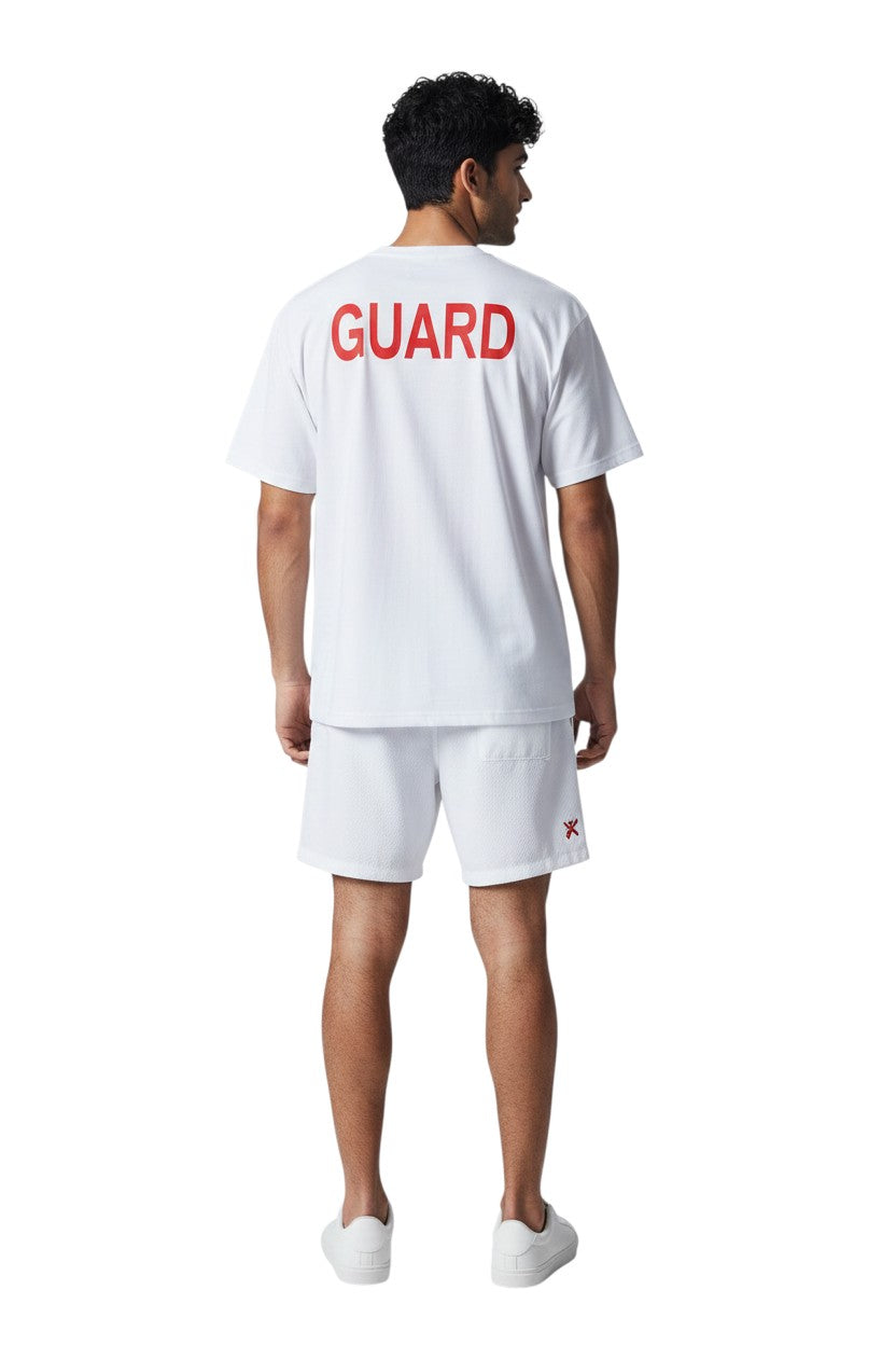 The Lifeguard Store white short sleeve Dri-Fit tee with red GUARD logo on back. 100% polyester.