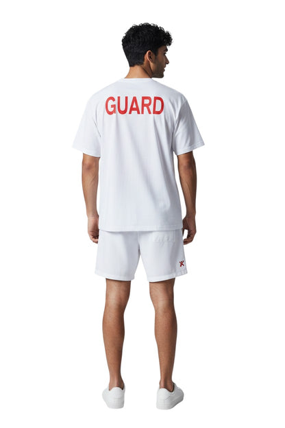 The Lifeguard Store white short sleeve Dri-Fit tee with red GUARD logo on back. 100% polyester.