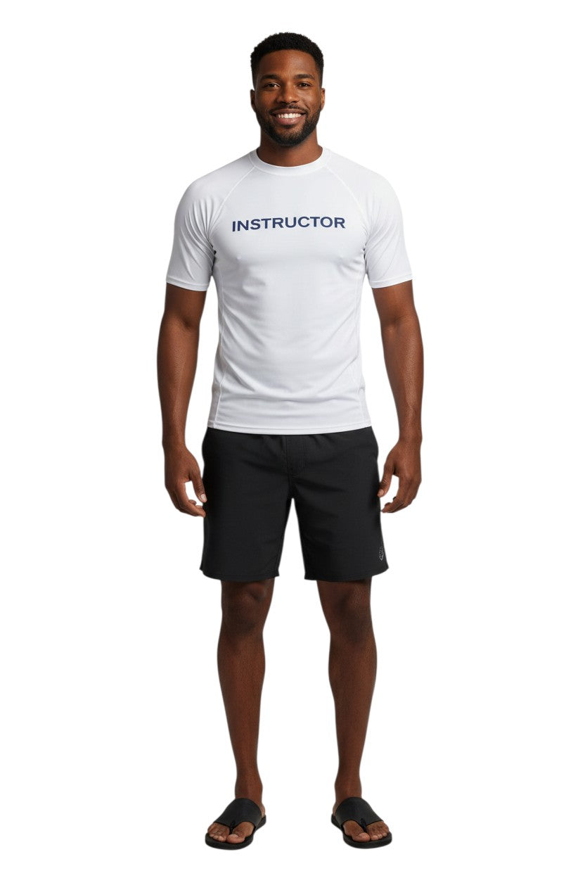 The Lifeguard Store white short sleeve rashguard with "INSTRUCTOR" printed in navy blue on the chest. Made of polyester and spandex.