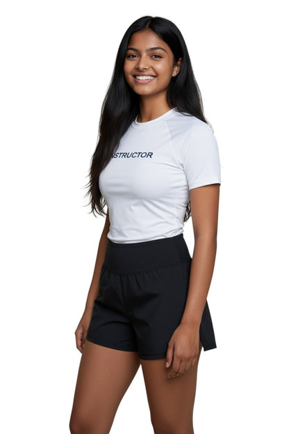 The Lifeguard Store white short sleeve rashguard with "INSTRUCTOR" printed in navy blue on the chest. Made of polyester and spandex.