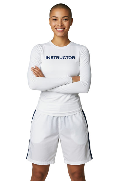 The Lifeguard Store white long sleeve rashguard with "INSTRUCTOR" printed on the chest. Made of poly-spandex blend for UPF50+ protection.
