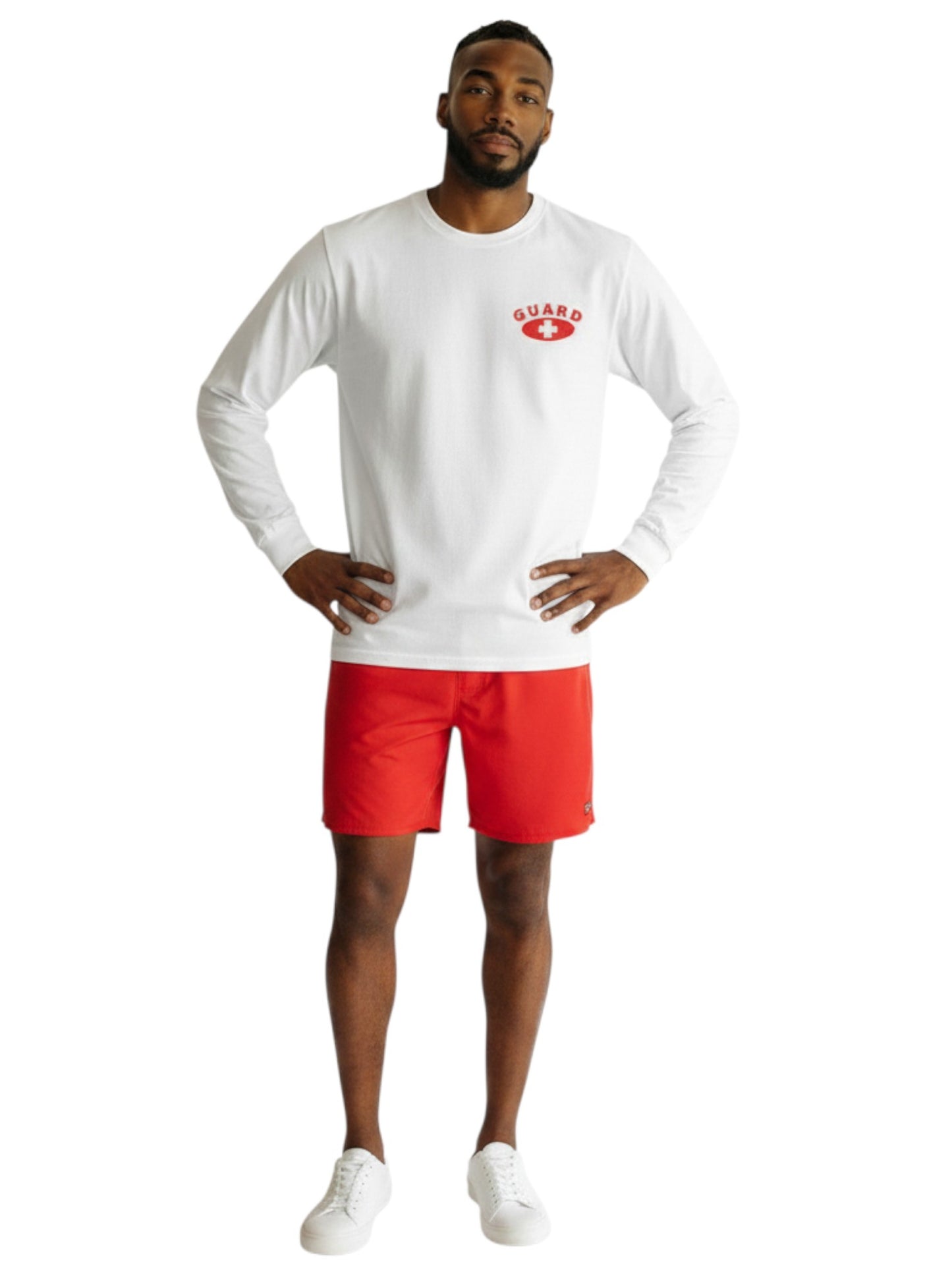 The Lifeguard Store white long sleeve cotton guard t-shirt with red logo worn by a male model with red shorts