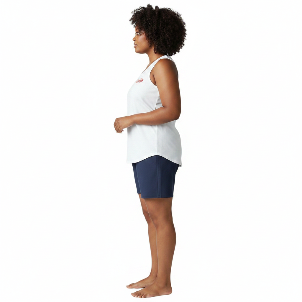 The Lifeguard Store white cotton Manager tank top worn by a woman, side view showing sleeveless fit and logo detail.