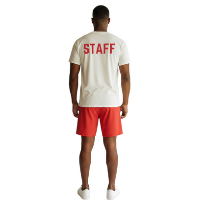 The Lifeguard Store white cotton staff t-shirt with red lettering on the back worn by a man with red shorts