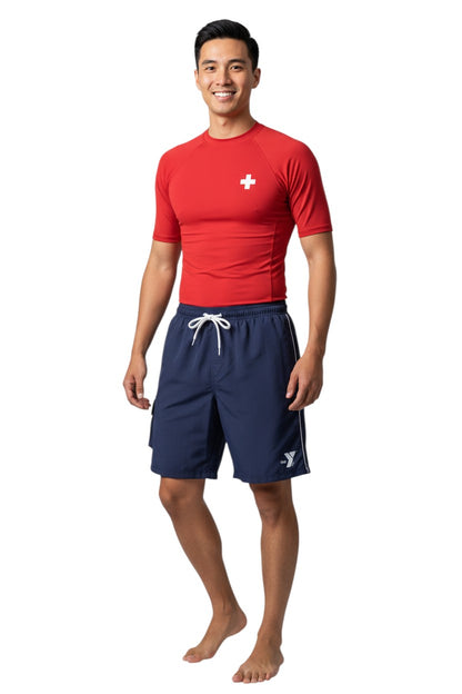 The Lifeguard Store navy blue YMCA board shorts with drawstring waist, cargo pocket, and white YMCA logo.