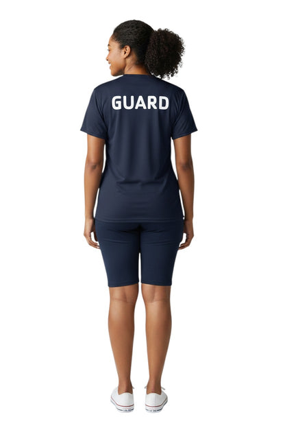The Lifeguard Store YMCA Guard Dri-Fit Tee, navy blue polyester shirt with white GUARD logo on back.