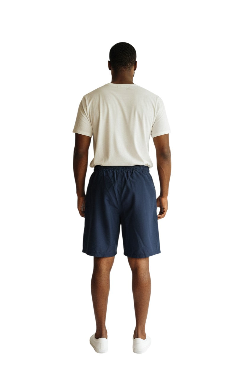 The Lifeguard Store navy blue polyester YMCA Instructor board shorts with elastic waistband and velcro pocket.