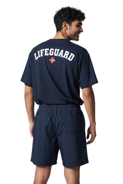 The Lifeguard Store YMCA Kiefer Instructor Board Short in navy blue polyester with elastic waistband and cargo pocket.